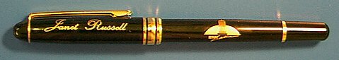 This is an ink pen with a logo engraved in a wrap around pattern on the body